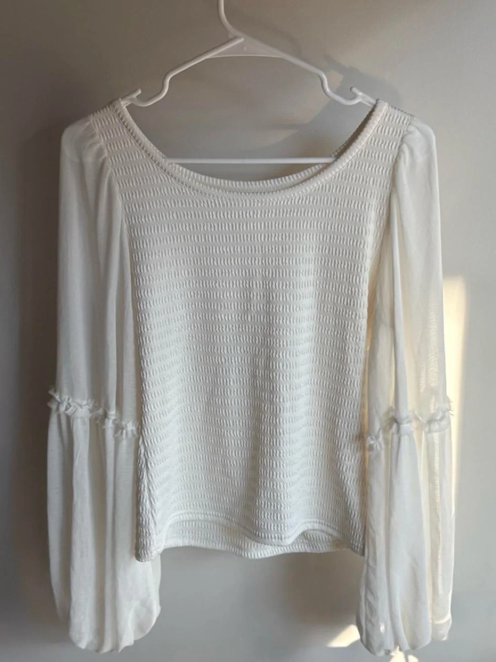 White flowy long sleeve top with ruffle detail